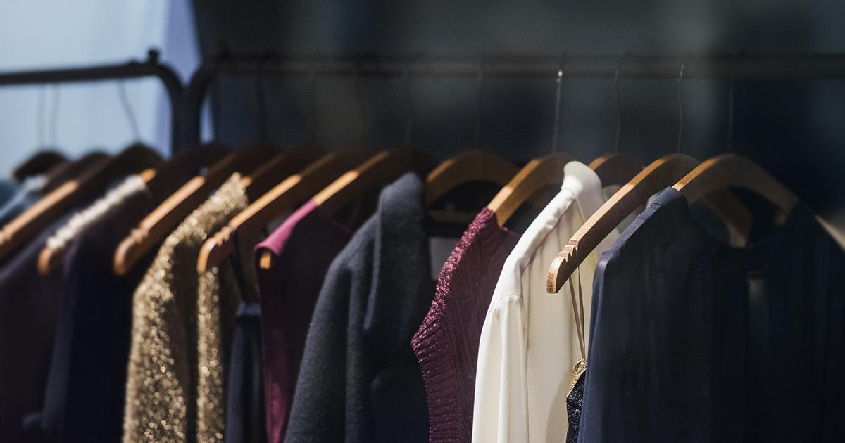 A curated clothing rack displaying garments on hangers, representing the premium selections typical in fashion rental services