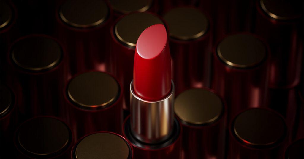 Close-up of a red lipstick with its cap off, among several closed lipsticks.