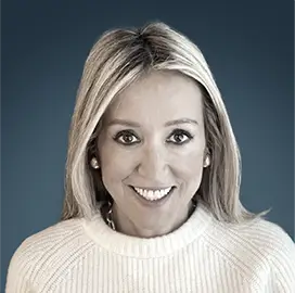 Marigay McKee – Co-founder and General Partner, Fernbrook Capital Management LLC | RLC Global Forum Portrait of Marigay McKee, Co-founder and General Partner of Fernbrook Capital Management LLC, wearing a white sweater, smiling against a blue background.