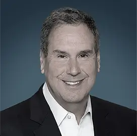 Stephen I. Sadove – Industry Consultant | RLC Global Forum Portrait of Stephen I. Sadove, Industry Consultant, wearing a dark suit and white shirt, smiling against a blue background.