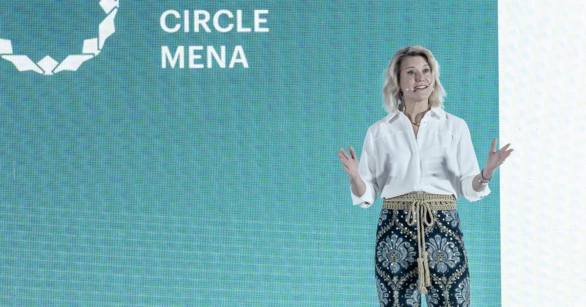 A female speaker delivering a keynote presentation in front of a teal background displaying Circle MENA branding at RLC Global Forum.