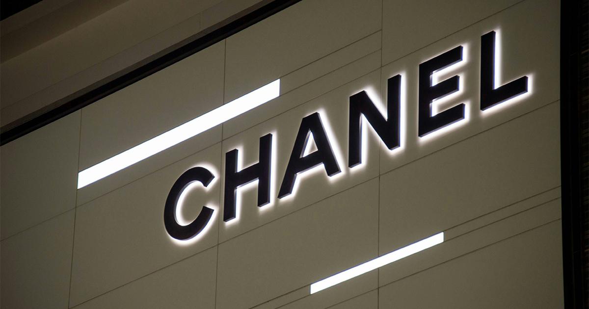 Illuminated Chanel store sign, symbolizing brand power and premium pricing in luxury retail.