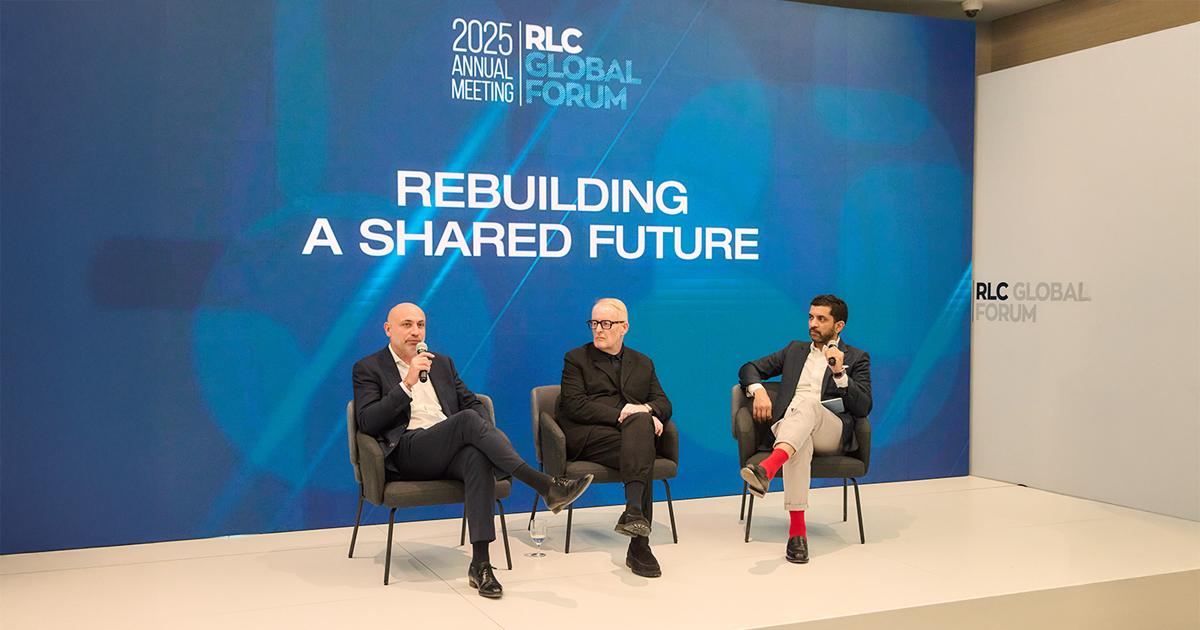 Three industry speakers participating in a panel discussion under the Rebuilding a Shared Future backdrop at the RLC Global Forum.