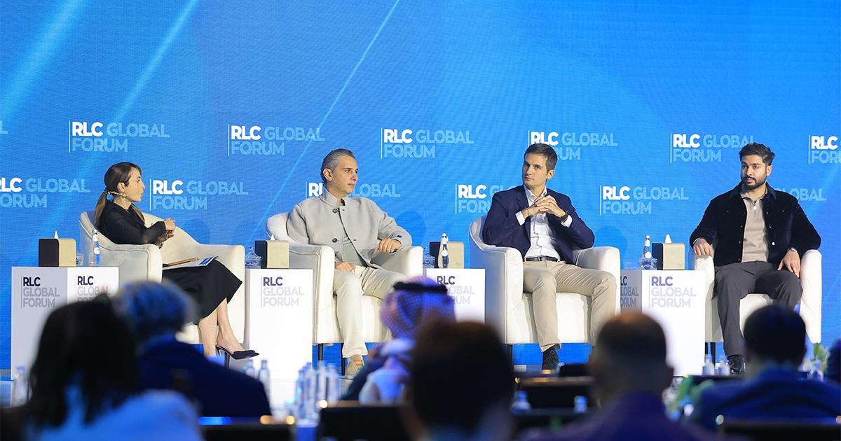 Four retail executives seated on stage in armchairs during a panel discussion at the RLC Global Forum.